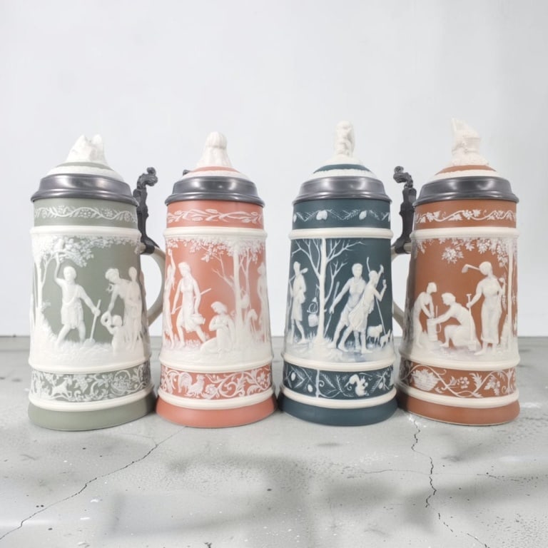 Set of 4 Mettlach Jasperware Steins "4 Seasons": Set of 4 Villeroy & Boch Mettlach Jasperware Steins "The 4 Seasons". Issued between 1978-1981. Stamped and dated. Winter, spring and summer are from a limited edition of 1000. Measure 11" H.