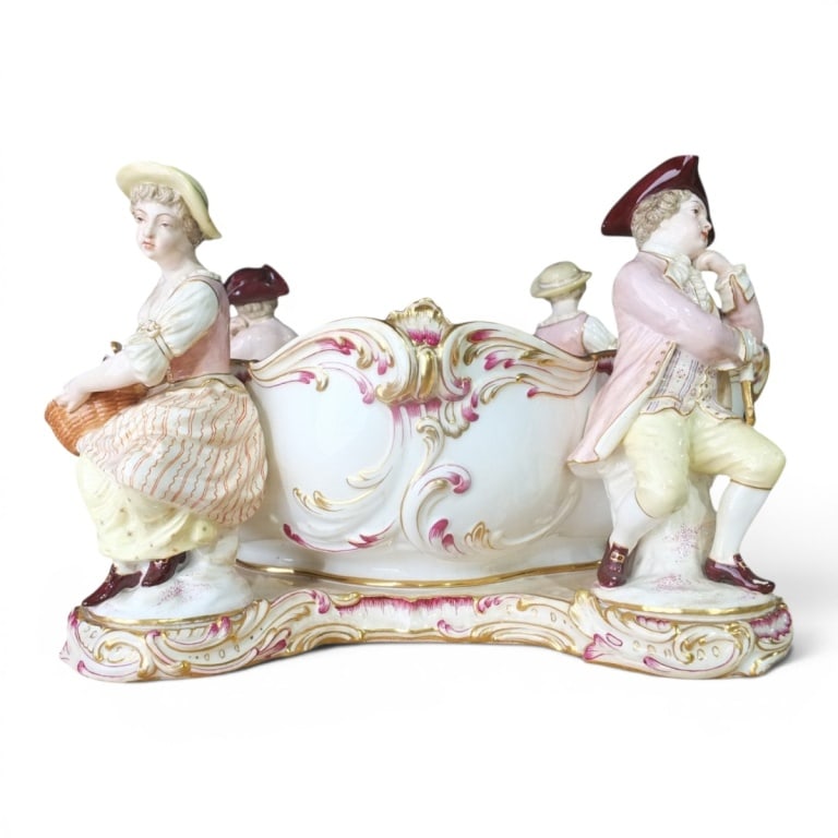 Antique Mintons Porcelain Figural Centerpiece Bowl: Antique Mintons Porcelain Figural Centerpiece Bowl. The large bowl adorned with 4 bolted period costumed figures, gilt highlights. Stamped Mintons on bottom. Measures 7-1/2" H x 13" x 10". Condition: