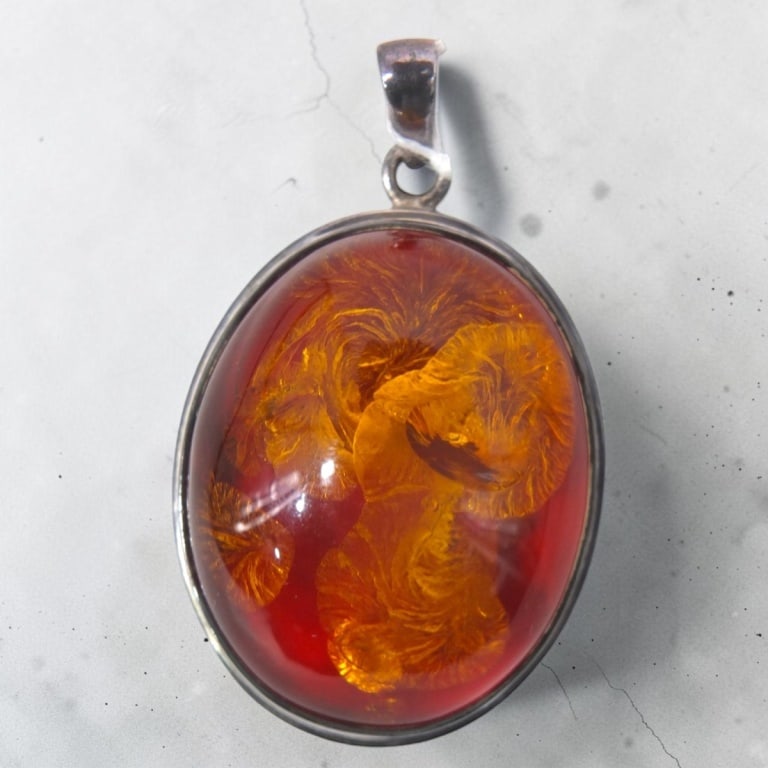 Vintage Baltic Amber & Sterling Silver Pendant: Vintage Baltic Amber & Sterling Silver Pendant. Stamped 925. Measures 1-7/8" x 1-1/2".