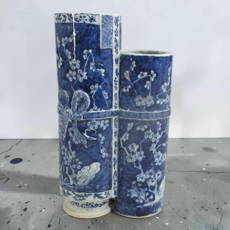 Vintage Chinese Blue & White Prunus Double Vase: Vintage Chinese Blue & White Prunus Double Cylinder Vase. With stylized bow detail. Unsigned. Measures 13-1/2" x 8" x 4". Condition: Extensive restoration Estimate 120 - 240 Domestic shipping Third Pa