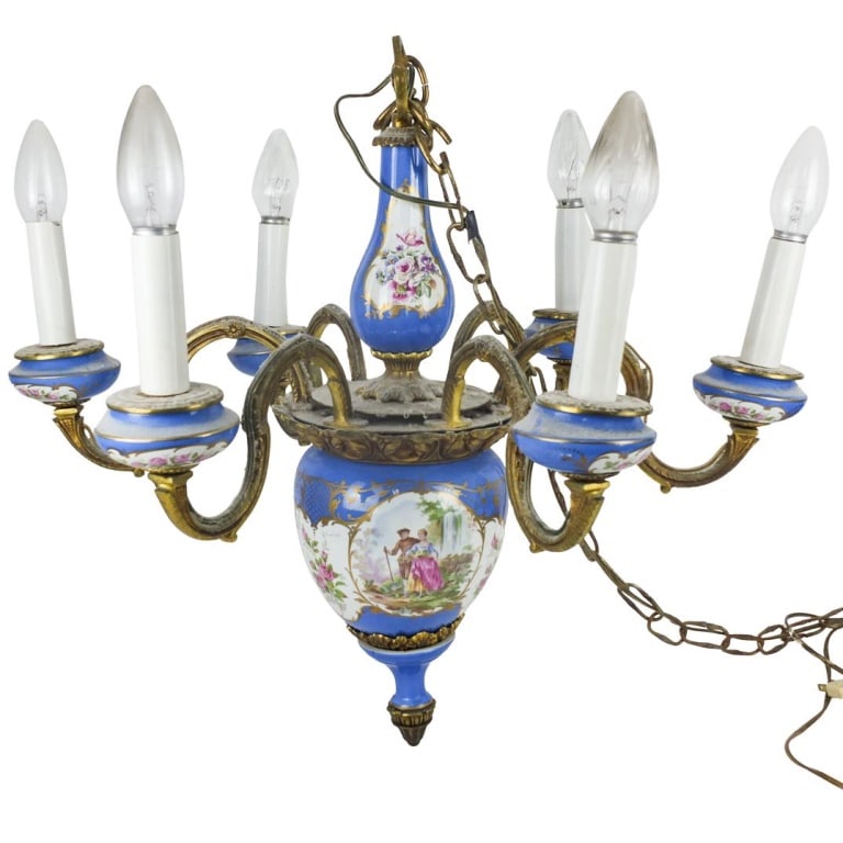 A Sevres Style 6-Arm Chandelier: A 19/20th Century French Sevres Style Gilt Bronze and Porcelain 6-Arm Chandelier. Measures 24" x 25". Condition: Fixture that holds the light needs to be tightened on a few lights. Some wear to