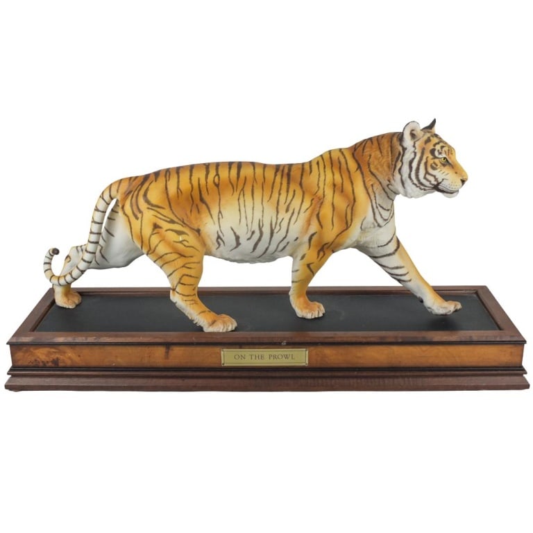 Large Franklin Mint Porcelain Tiger Statue: Large Franklin Mint Porcelain Tiger Statue with Presentation Stand. Titled "On the Prowl" and signed on the base. Tiger measures 10-1/4" x 22-1/4" x 5". Base measures 2-3/4" x 25-1/4" x 8". Condition:
