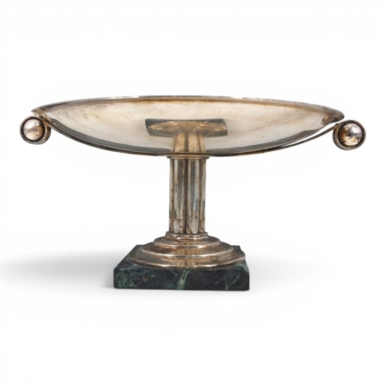 Vintage Art Deco Silver Plate Tazza Centerpiece: Vintage Art Deco Silver Plate Tazza Centerpiece. Features loop and ball handles and a column support on a raised marble base. Unsigned. Measures 7" x 15-1/4" W handle to handle. Condition: Wear to