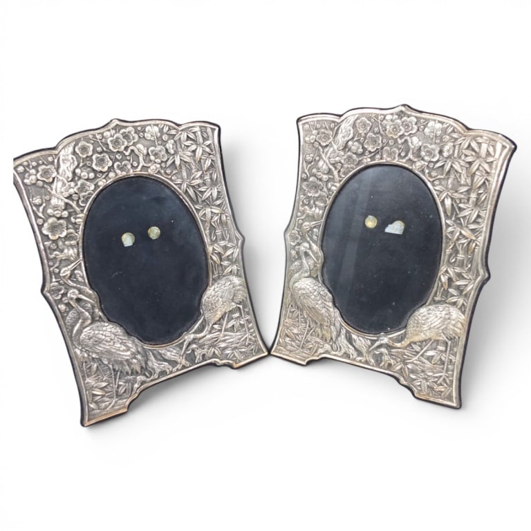 Pair Vintage Royal Selangor Pewter "Bamboo" Frames: Pair Vintage Royal Selangor Pewter Repousse Frames. Features bamboo, flowers and birds motif. Unmarked. Measures 8" x 6", opening 4-3/4" x 3-1/2". Condition: Good condition. Estimate 60 - 100