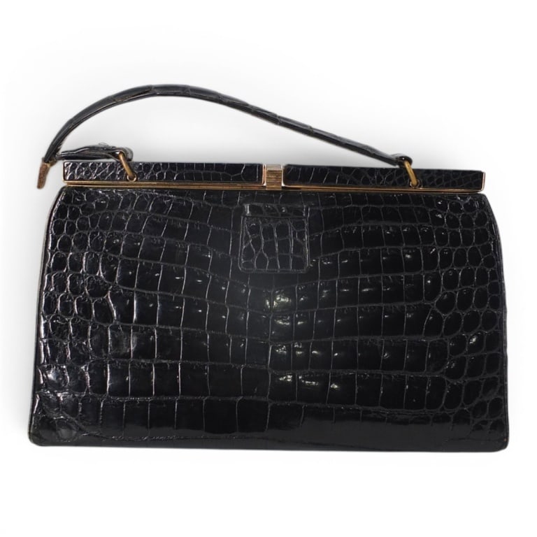 Mid Century Rendel Black Alligator Purse: Mid Century Rendel Black Alligator Purse. Retailed by Julius Garfinkel Co. Washington. DC. Leather pocketed interior, coin purse. gold tone hardware. Labeled appropriately. Measures 6" H x 11" W x