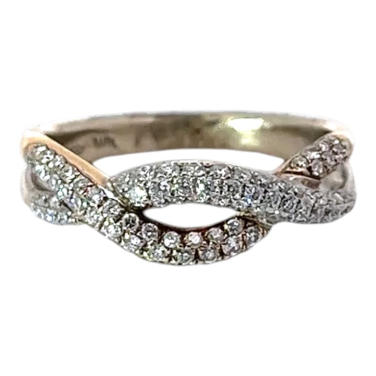 Vintage Diamond and 14K Knotted Ring: Vintage Diamond and 14 Karat Yellow Gold Two-Toned Knotted Ring. Stamped. Diamonds: .75 TCW. Size: 7. Approx. weight: 3.3 grams. Condition: Good condition. Estimate 800 - 1200 Domestic shipping Third
