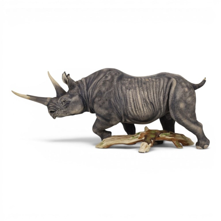 Boehm Porcelain Limited Issue Black Rhinoceros: Boehm Porcelain Limited Issue Black Rhinoceros Sculpture. Signed, original label: #10, 1986. Measures 9-1/2" H x 24" L x 6-1/2" W. Condition: Examined under black light, Tail needs repair, (piece