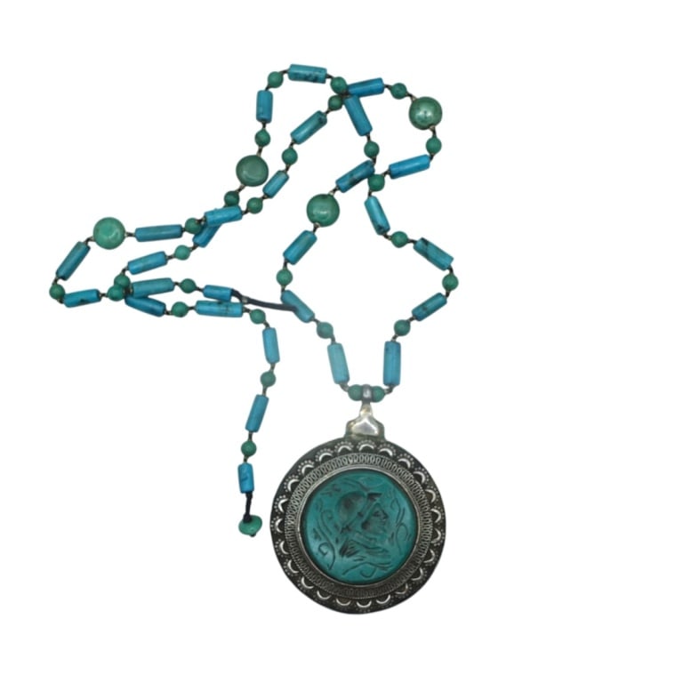 Afghan Turkmen Silver Plate Turquoise Necklace: Afghan Turkmen Silver Plate Turquoise Necklace. Features a green turquoise intaglio carved pendant. Unsigned. Measures 15" L, the pendant 2-1/2". Condition: Good condition. Estimate 100 - 200 Domestic