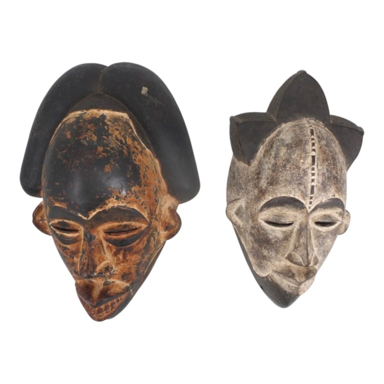 2 Vintage West African Carved Wood Tribal Masks: 2 Vintage West African Carved Wood Tribal Masks. Unsigned. Larger measures 14" x 10" x 6". Condition: Good vintage condition consistent with age, display and storage. Estimate 150 - 350 Domestic shipp
