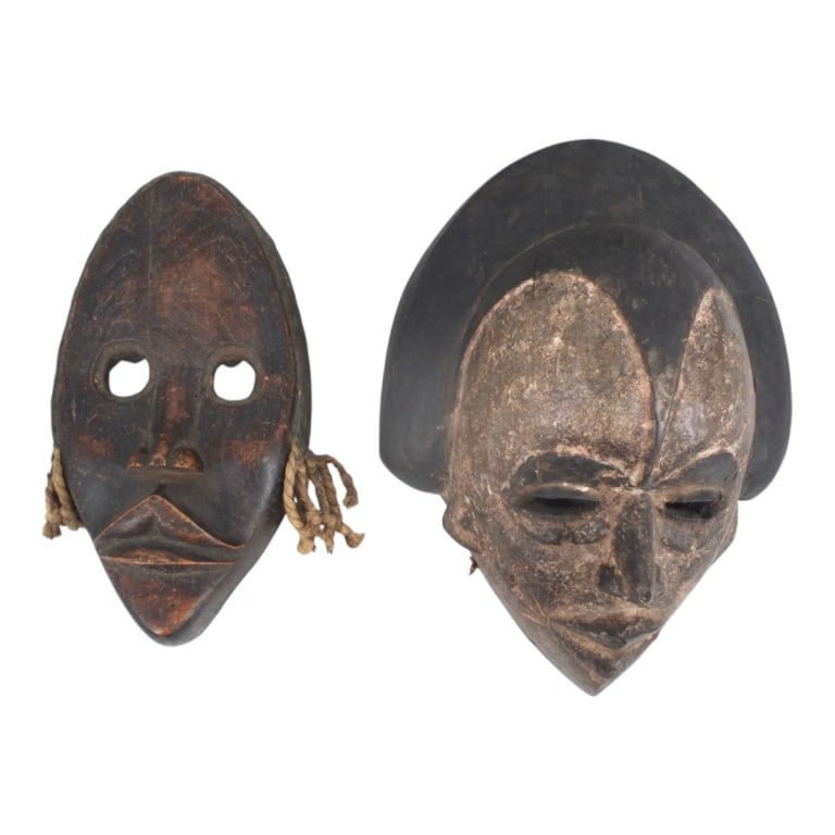 2 Vintage West African Carved Wood Tribal Masks: 2 Vintage West African Carved Wood Tribal Masks. Unsigned. Larger measures 14" x 10" x 6". Condition: Small losses to edges or in good vintage condition consistent with age, display and storage. Estim