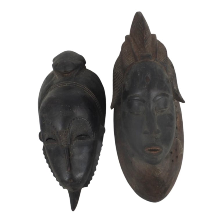 2 Vintage African Ivory Coast Carved Wood Masks: 2 Vintage African Ivory Coast Carved Wood Masks. Unsigned. Measures 16" x 6-1/2" and 14" x 6". Condition: Good vintage condition consistent with age, display and storage. Estimate 100 - 300 Domestic s