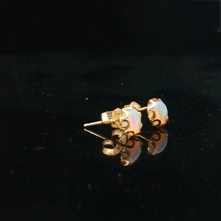 Pair of 14k Yellow Gold Opal Stud Earrings: Pair of Vintage 14 Karat Yellow Gold Oval Shaped Opal Stud Earrings. Condition: Good condition. Estimate 100 - 200 Domestic shipping Third party
