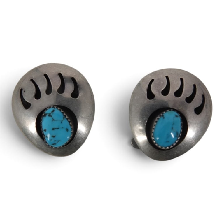 2 Vintage Navajo Turquoise Silver Bolo Tie Slides: 2 Vintage Navajo Turquoise and Silver Bolo Tie Slides with bear paw motif. Unmarked. Measures 1-1/4" x 1-1/8". Total weight approx. 17.24 grams. Condition: Good condition. Estimate 50 - 100 Domestic
