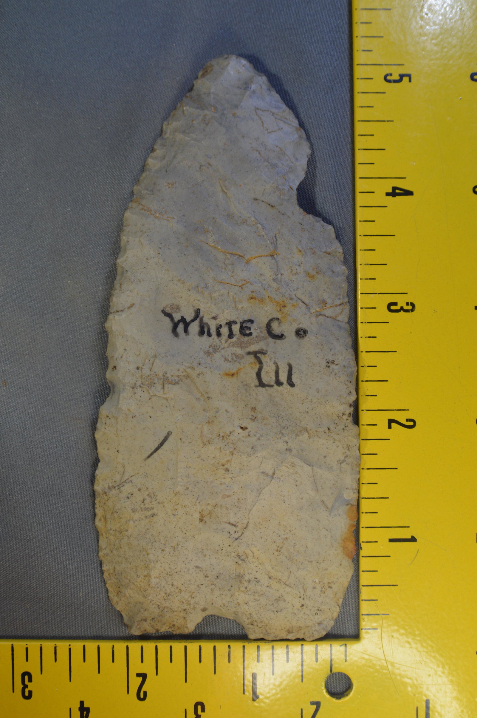 5 1/8" Clovis Preform. Ex; J. G. Braecklein: 5 1/8" Clovis Preform Found in White Co. Illinois. Rare type and Size for a Paleo Artifact. 2 1/4" Wide. Ex: J. G. Braecklein Collection.