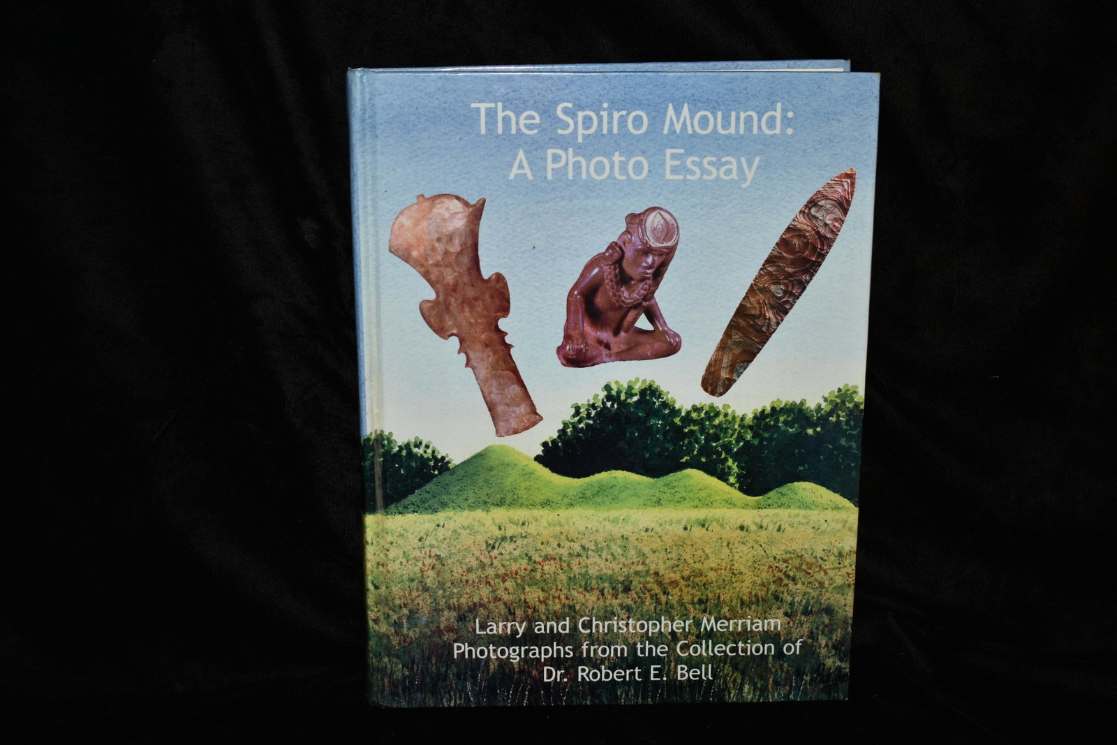 THE SPIRO MOUND: A Photo Essay Signed: Spiro Mound: A Photo Essay by Larry & Christopher Merriam 2004 1st Edition. SIGNED BY BOTH AUTHORS. Good condition. Has a couple friction blemishes on the board edges. Hardback 408 pgs 11 3/4" by 8 3/