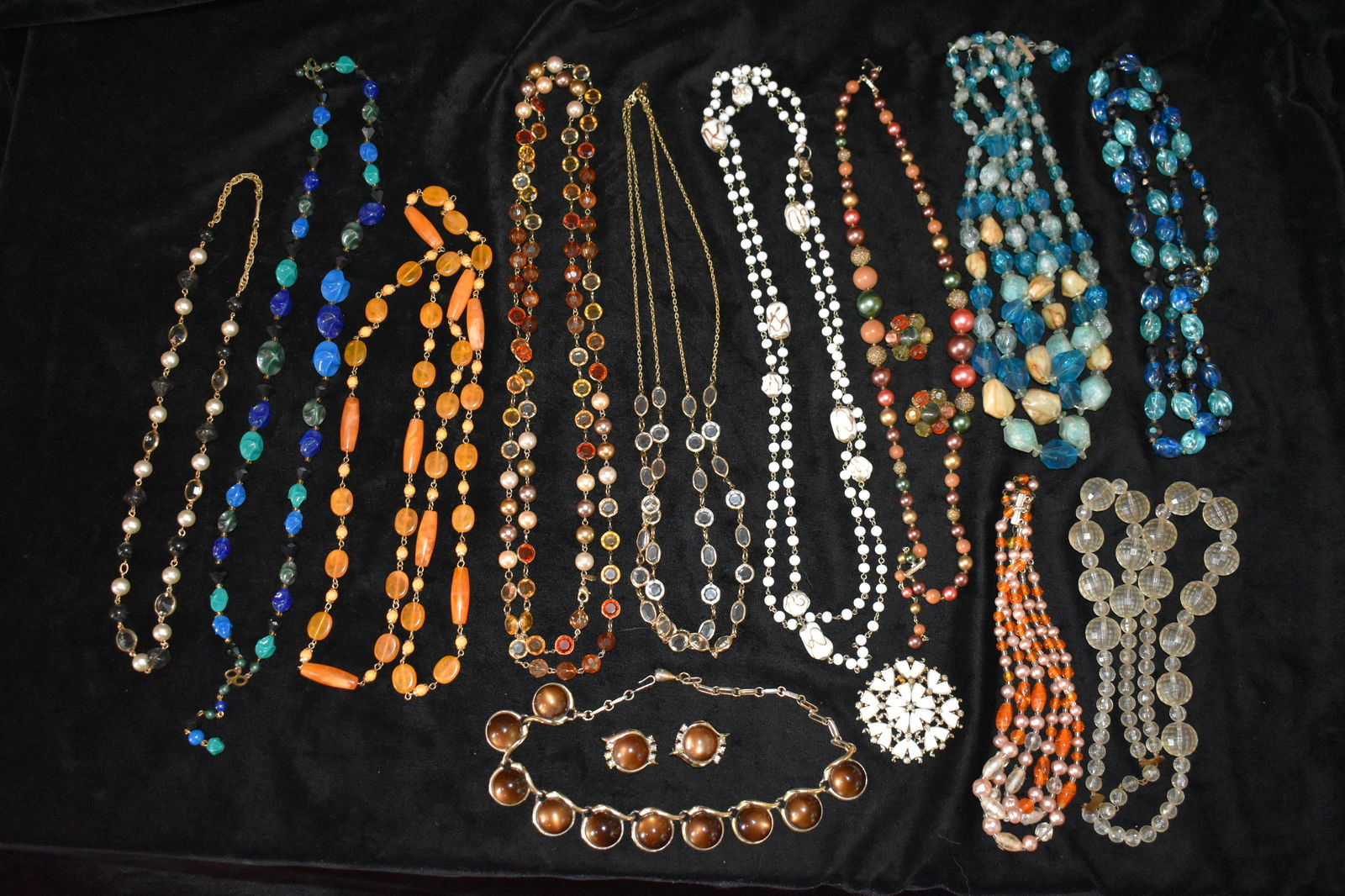 15 Piece Vintage Costume Jewelry Collection: This assortment of costume jewelry is mid 19th century. The White necklace in the middle is 1950's Milk Glass Lamp work by Coro. Very nice clean piece for its age. The White bead broach appeared to go