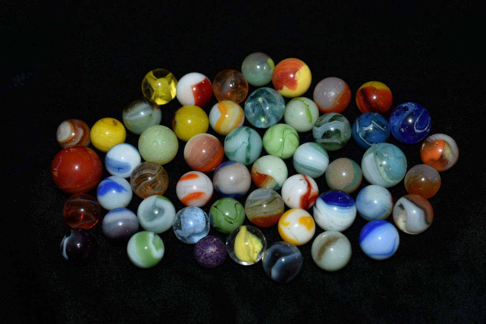 50 Old Collectible Marbles: The marbles in this group are a mix of various makers. Akro agate, Alley, Champion, Alox, Peltier etc. Some saw game play others didn't. Age will vary from late 1800's to circa 1960s. 5/8" to 3/4"