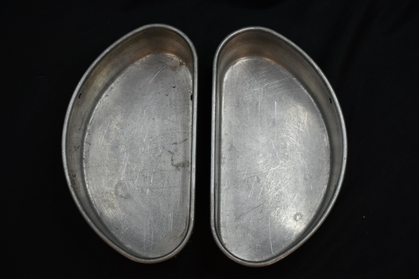 2 Pressed Aluminum Pans: Not sure of the use. They are identical and more than likely military.