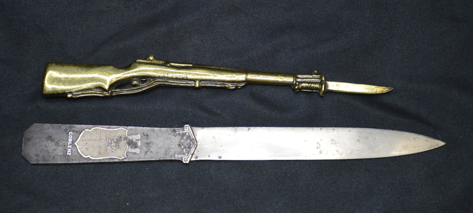 2 Letter Openers: The silver colored one has Coblenz on it. The gold colored gun shaped one says Municipal Auditorium St. Louis MO on it.
