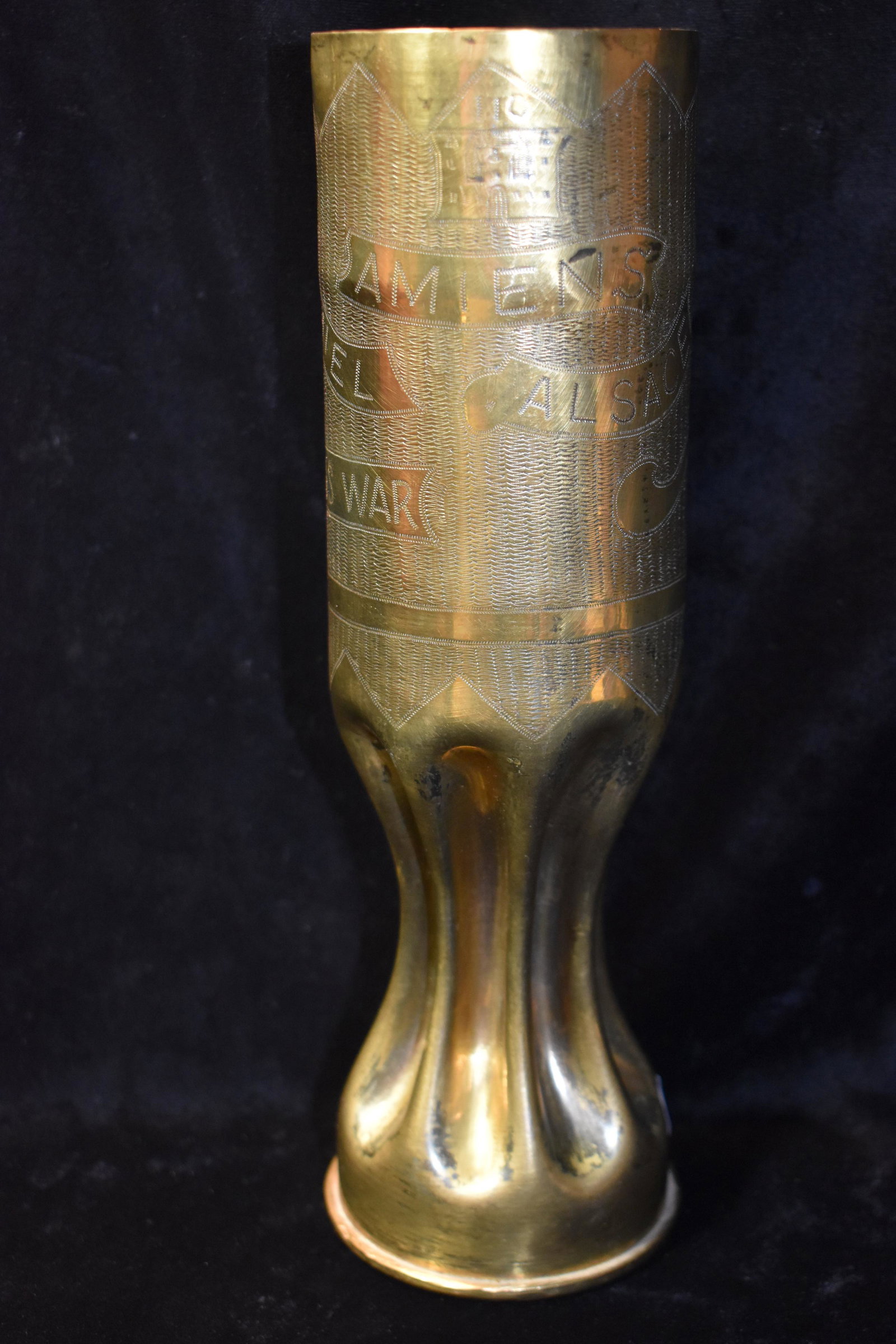 1917 WW1 AMIENS ALSACE 75MM Trench Art Casing: 1917 WW1 AMIENS ALSACE 75MM Trench Art Casing. This casing commemorates the city of "AMIENS ALSACE" in "1918" "WORLDS WAR" and the battles of "ARGONNE" and "ST MIHIEL". All of the inscriptions are on 