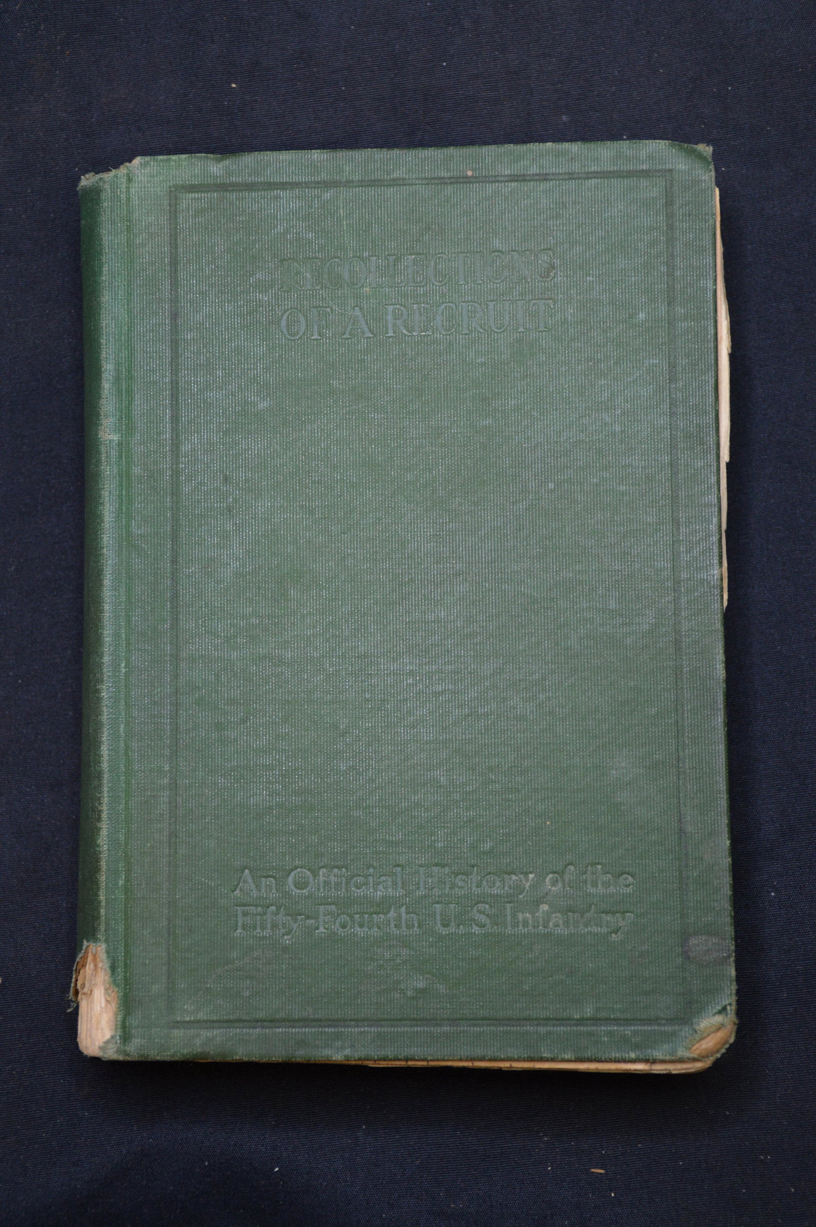 Recollections of a Recruit an Official History of the: Pertaining to WW1 with maps of the movement and a newspaper article of the 54th. Book is in fair condition with some loose pages and part of the covere missing at the spine.