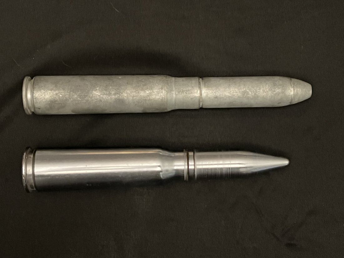2 Deactivated dummy Bullets: The longes is 7 1/4 inches and has cartridge drill M18A1 20MM Gun on it. The other shell has no marking and is 6 1/2 inches long.