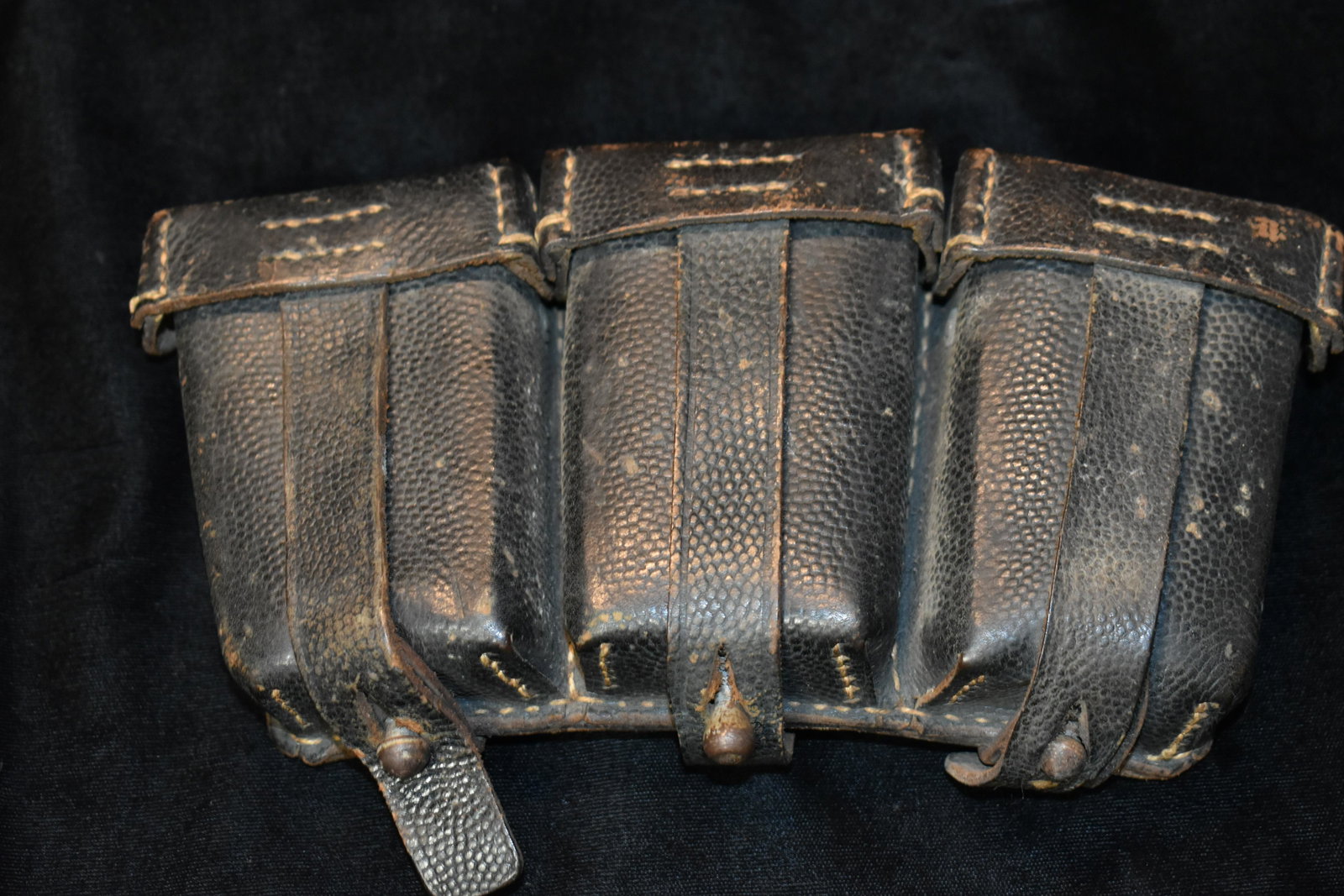 1940 Triple Ammo Pouch with Oilers: The back has manufacture data embossed on it. See picture. It appears to say " CPOSE" with another long word we couldnt make out dated "1940". Very good condition for its age. Measures 8 1/2" by 4 1/4
