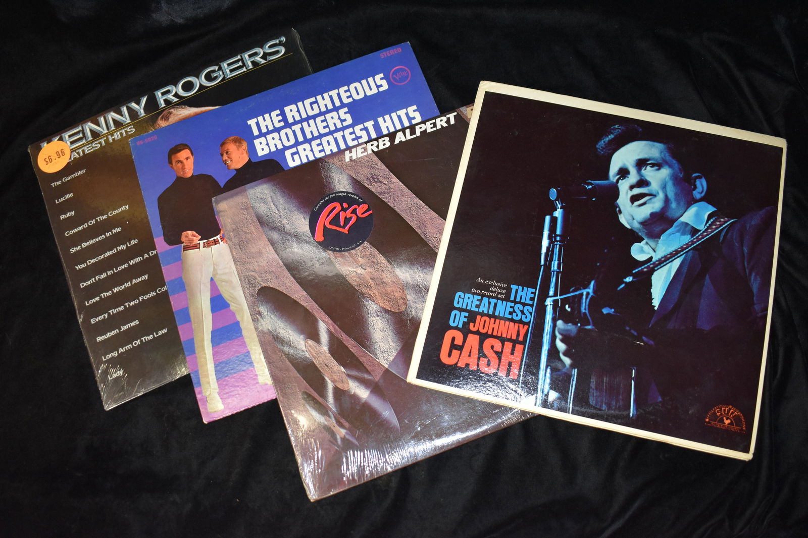 4 Albums from the 1960's and 70's Johnny Cash, The Righteous Brothers: The Greatness of Johnny Cash 93213. Cover VG, Album Side 1 & 2 has light scratches, 3&4 excellent condition; ; 1979 Herb Alpert - Rise SP 4790. Cover is VG+, album has a couple scratches; 1967 The Rig