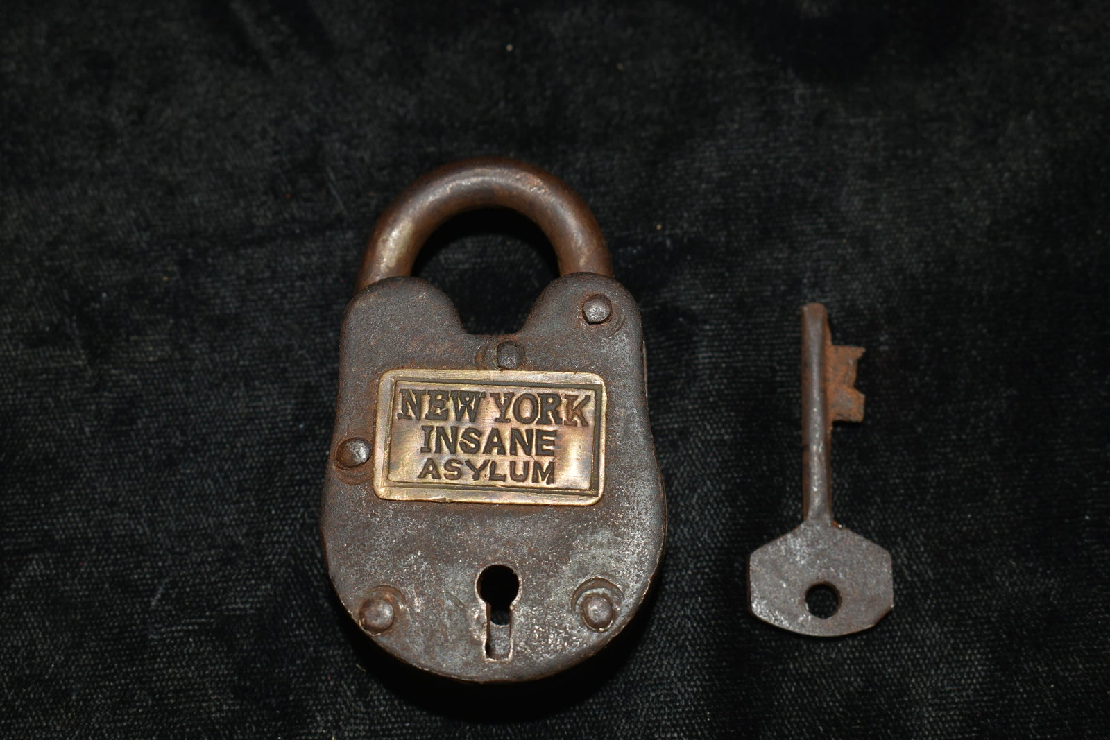 New York Insane Asylum Lock and Key: New York Insane Asylum Lock and Key. This is a historic reproduction. Lock and key work. Reads "NEW YORK INSANE ASYLUM". Measures 2 1/2" by 1 1/2"