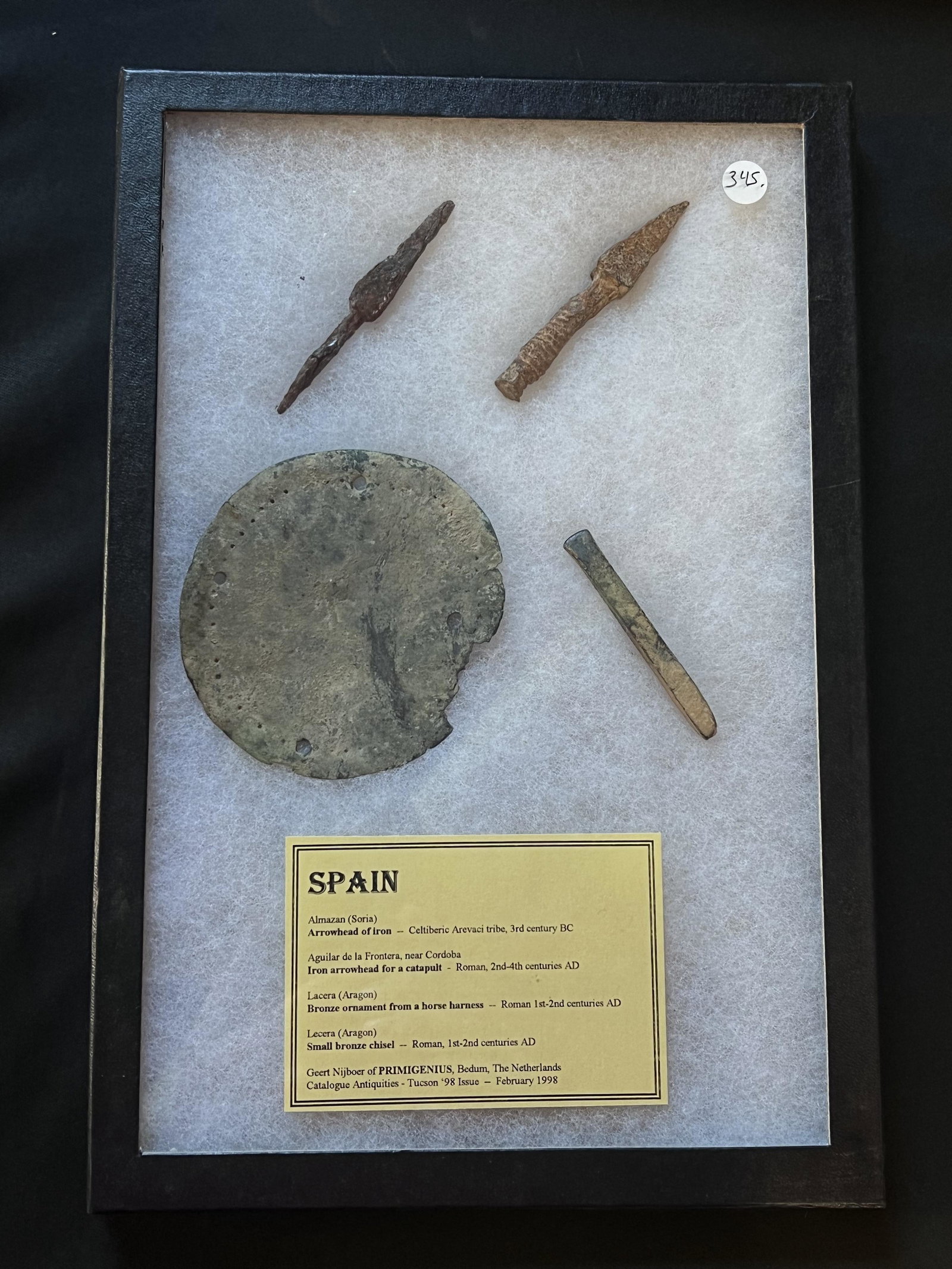 Spain Artifacts. Arrowhead of Iron, Bronze ornament from a horse harness, bronze chisel. Dated: Spain Artifacts. Arrowhead of Iron, Bronze ornament from a horse harness, bronze chisel. Dated between 300 BC and 400 AD. The case is included. Ex: John Grenawalt Collection.