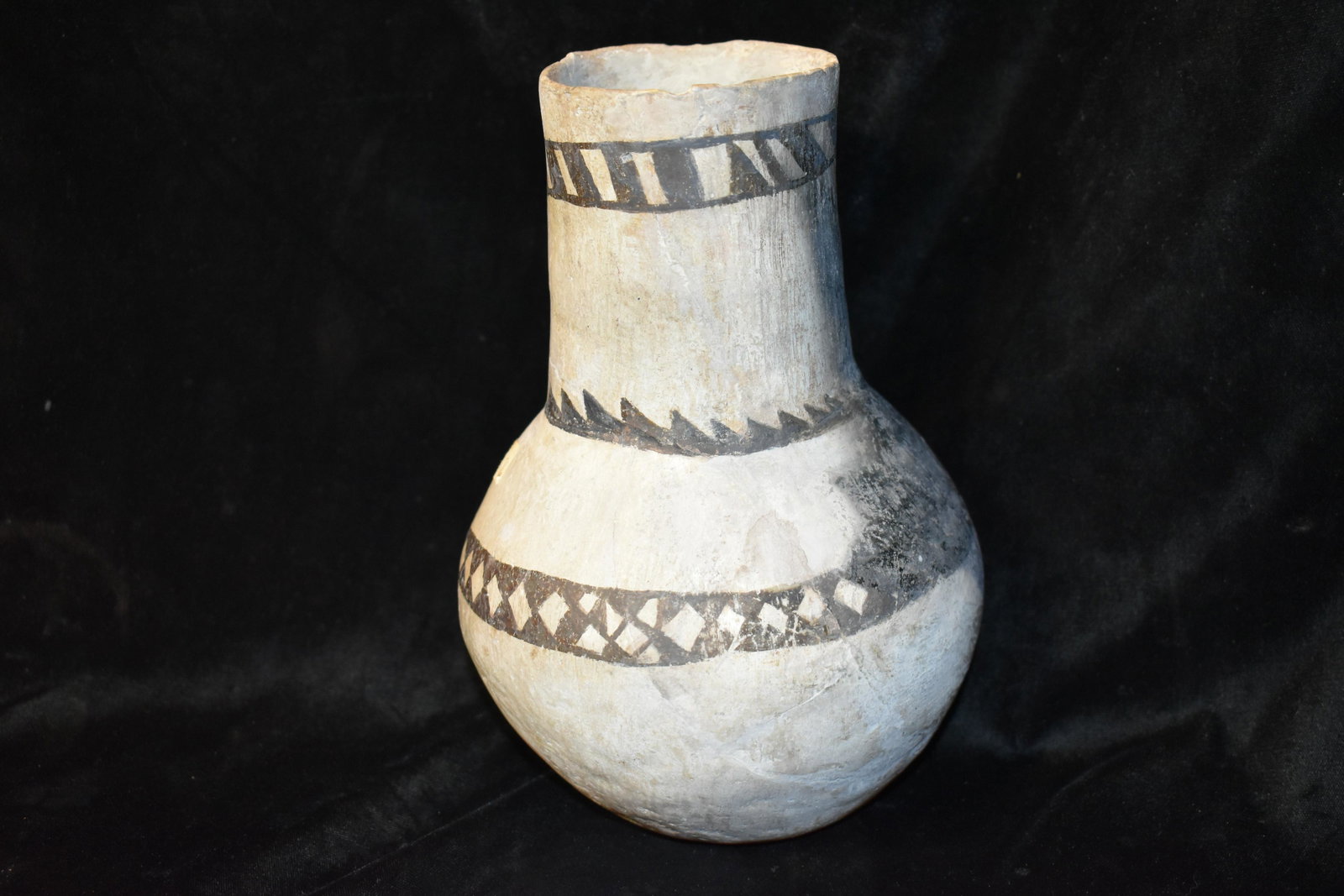 8 3/4" Anasazi Black on White Pottery Vase: 8 3/4" Anasazi Pottery Vase. This appears to have been found in a few big fragments. There has been a little restoration (minor restoration in the black area of the pot) and cover up work on the exter