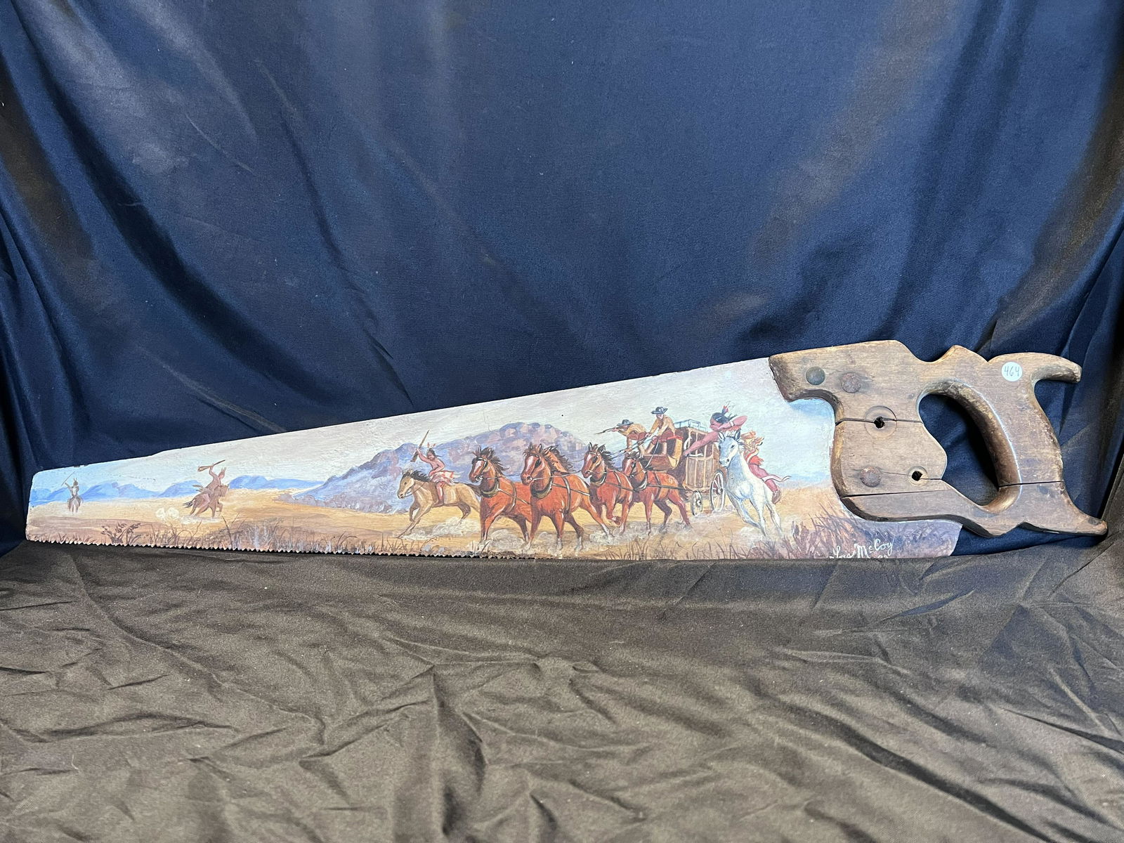 Hand Saw Painted by Lois McCoy in 1982. Indians attacking the stage coach. The length is 28 3/8: Hand Saw Painted by Lois McCoy in 1982. Indians attacking the stage coach. The length is 28 3/8 inches.