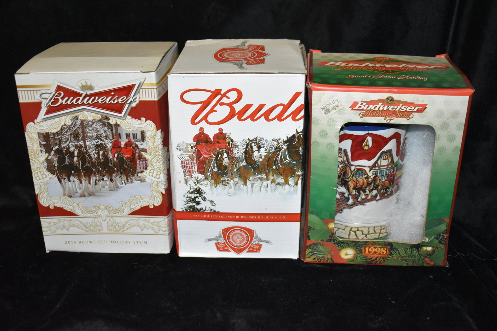 3 Budweiser Holiday Steins 1998, 2011 &2014 New in the Box.: 2 Budweiser Holiday Steins 1998, 2011 &2014 New in the Box. Both are in New condition in their original boxes. They measure 7" Tall