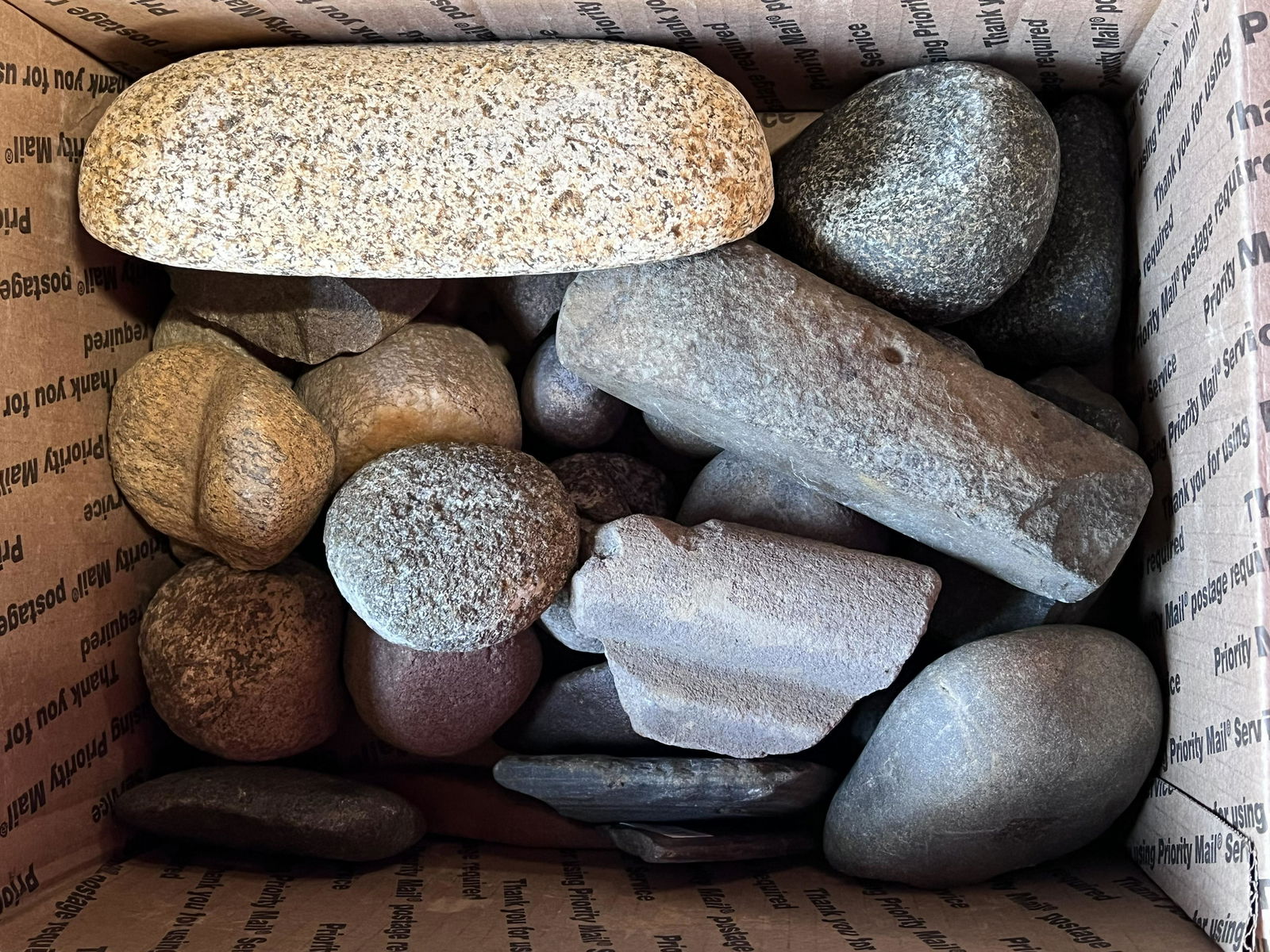 Large Group of Hard Stone Tools in a Medium Flat Rate Box. Includes Abraiders, Mano, Gorgets, Celts: Large Group of Hard Stone Tools in a Medium Flat Rate Box. Includes Abraiders, Mano, Gorgets, Celts and hammerstones.