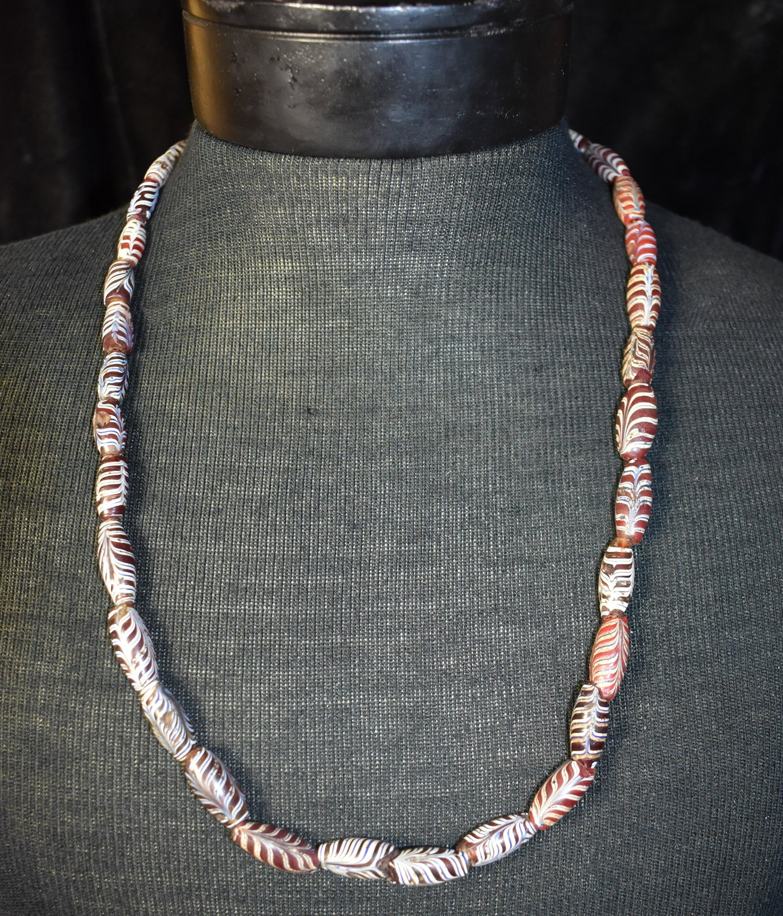 27" Strand Necklace of Feather Trade Beads: Strand Necklace of Feather Trade Beads. The beads in this strand appear to be in very good to excellent condition for their age. They have some patina from age. The strand measures approximately 27"
