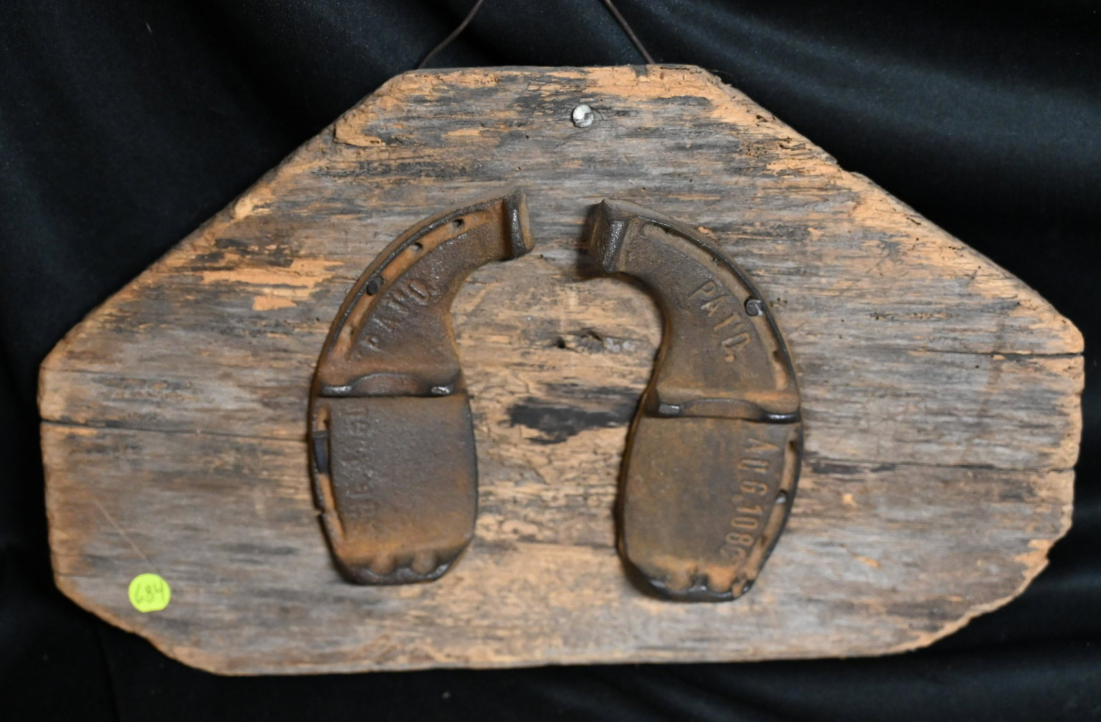 Pair of Ox Shoes nailed on a piece of barn wood with square nails. Dated back to the 1800's and: Pair of Ox Shoes nailed on a piece of barn wood with square nails. Dated back to the 1800's and very rare. Made to hang on the wall as a picture this would look great in any rustic dÃ©cor and are de