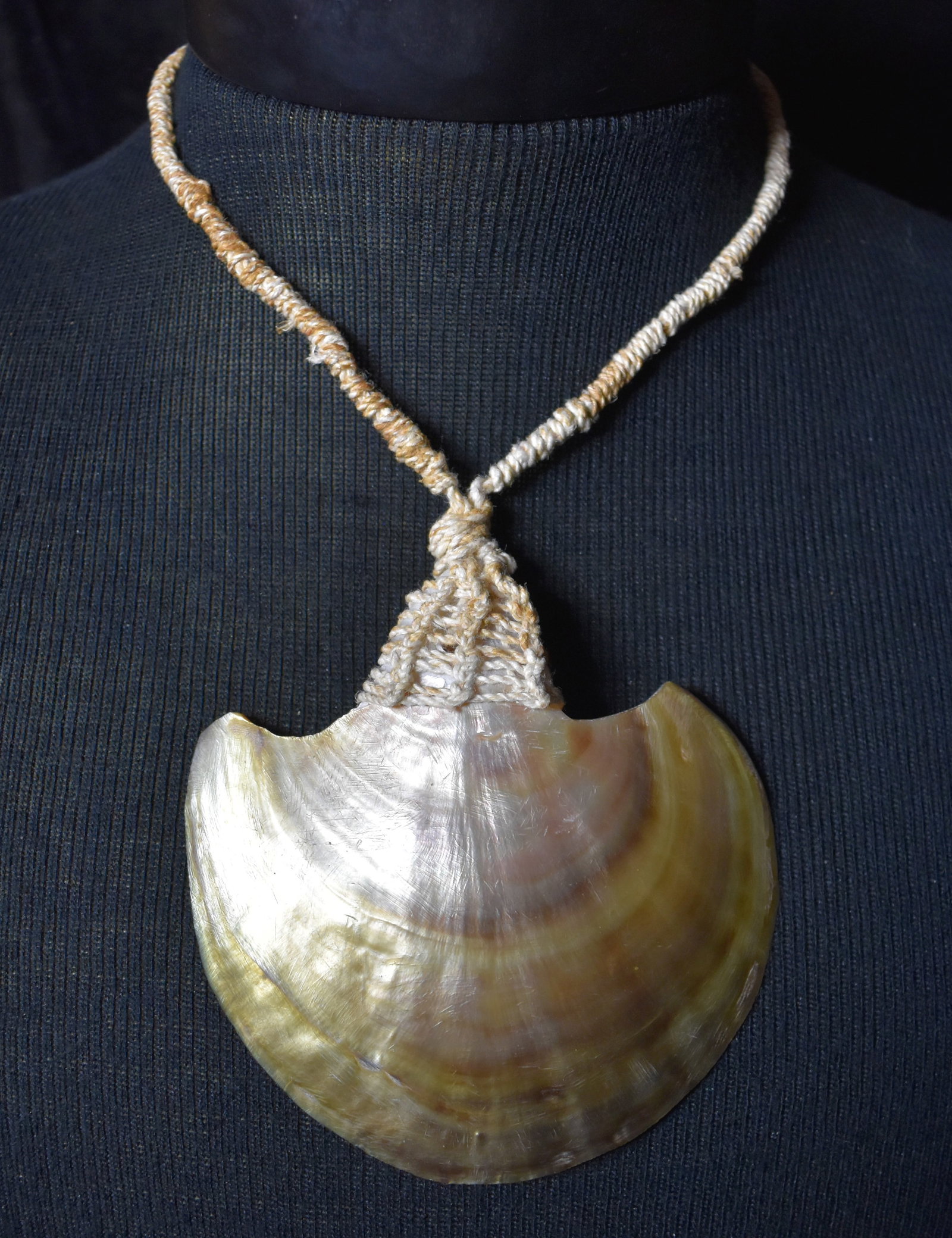 Polynesian Gold Mother of Pearl Hand Braided Necklace: Huge gold mother of pearl shell braided with satin cord and cowry shell fastener. Measures 18". Shell is 4 1/8" Wide.