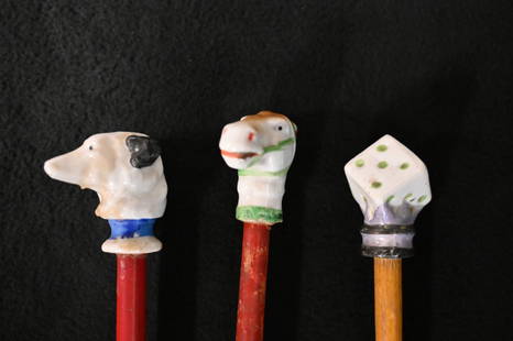 3 Carnival Canes with a Ceramic/Porcelain Top of Dice, Horse & Dog figures on top and a wood rod.: 3 Carnival Canes with a Ceramic/Porcelain Top of Dice, Horse & Dog figures on top and a wood rod. The cane is 36" long. Given out as prizes for winning Carnival/Circus Games.