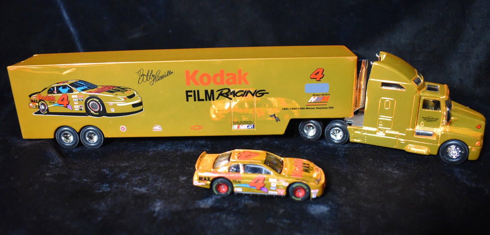 Under Lights Gold Nascar Car Transporter w/ Car Kodak 4 1999: Racing Champions Under Lights Gold Nascar Car Transporter w/ Car Kodak 4 1999. 1:64 Scale. New in the Box.