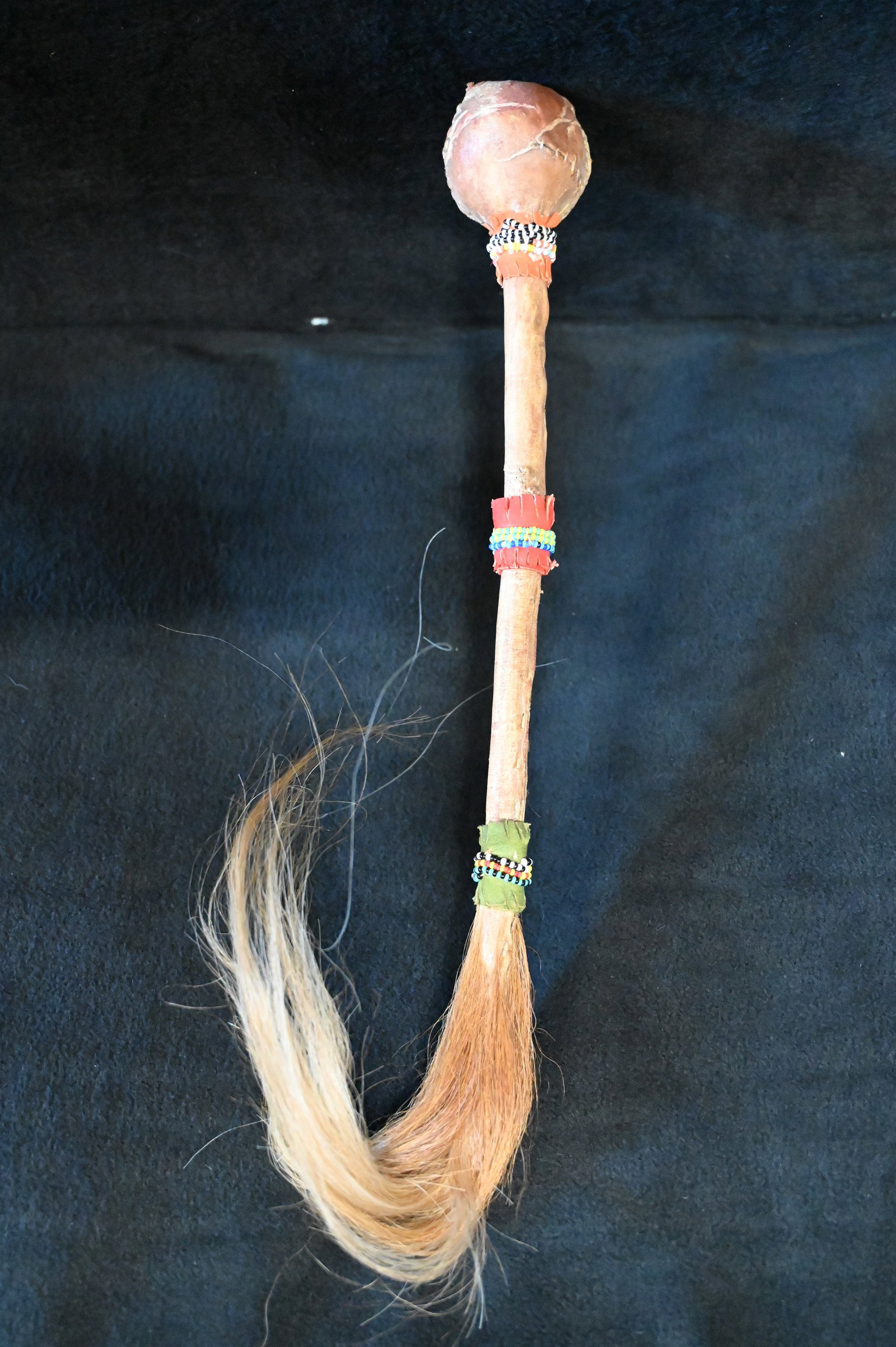 War Club with Horse Hair Drop: War Club with Horse Hair Drop. 16" Long with hardened leather wrapped around the club and beadwork on the handle.
