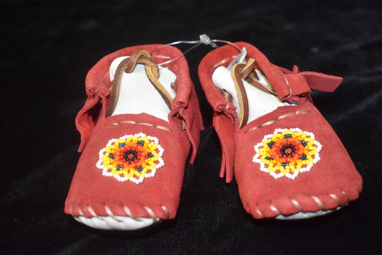 OTN Leather & Beadwork Booties/Moccasins Authentic Native American Artistry: OTN Leather & Beadwork Booties/Moccasins. Made for a small child these small shoes are new/never worn. The souls of the shoes measure about 4 1/4" long. We couldn't figure out what OTN means (one defi