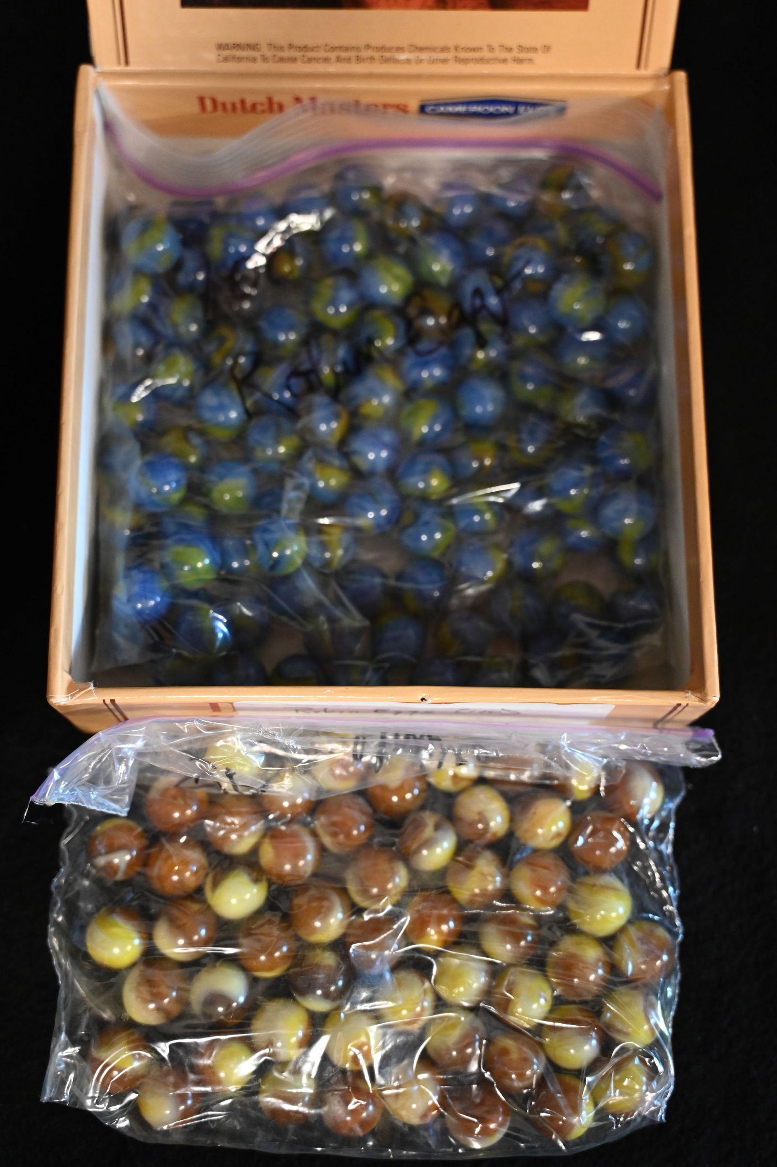 100 Robin Egg Marbles and 50 Sunflower Marbles in a Dutch Masters Cigar Box. The size of the: 100 Robin Egg Marbles and 50 Sunflower Marbles in a Dutch Masters Cigar Box. The size of the marbles is 5/8".