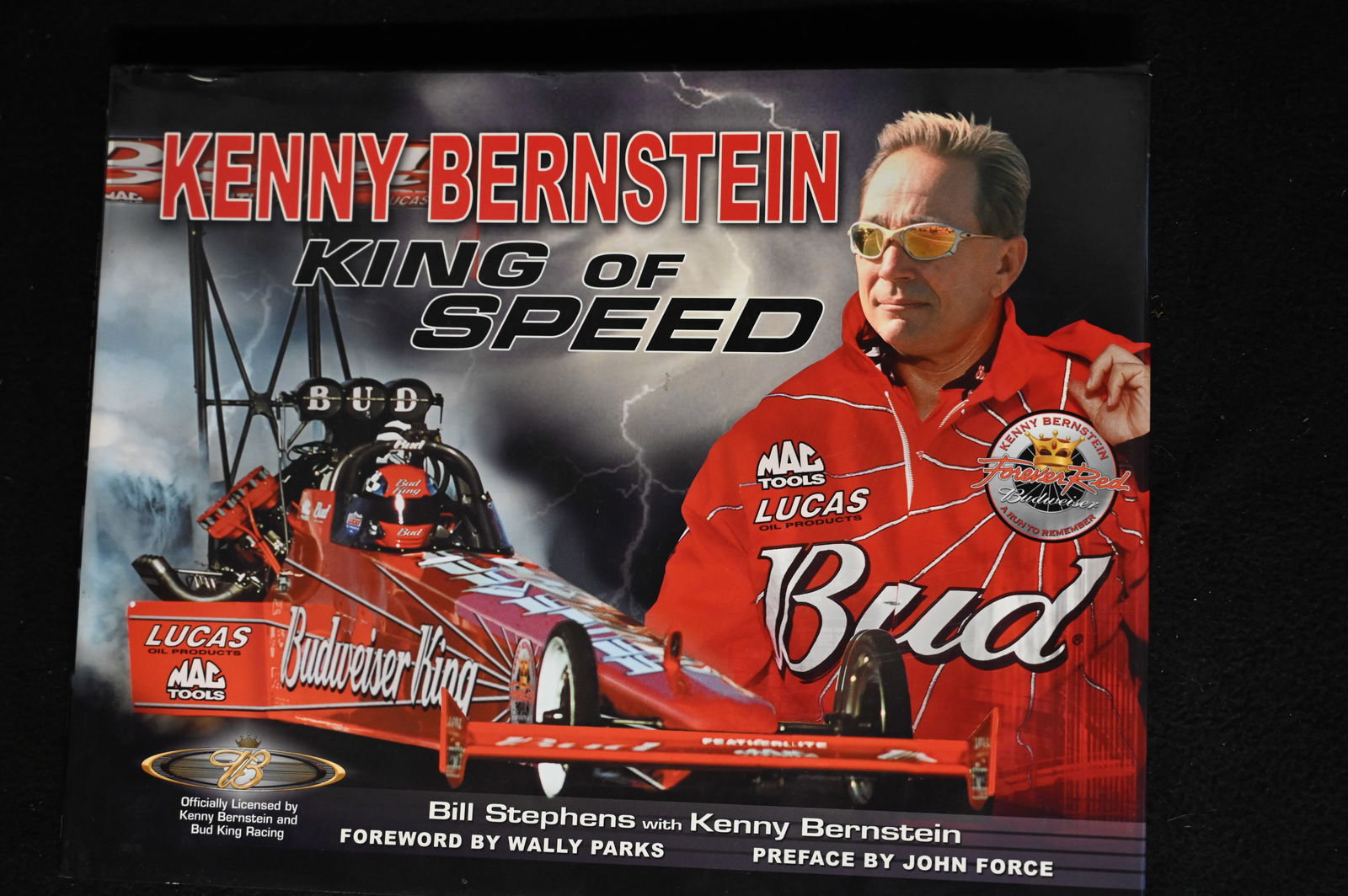 Kenny Bernstein King of Speed signed by ? by Bill Stephens with Kenny Bernstein foreword by Wally: Kenny Bernstein King of Speed signed by ? by Bill Stephens with Kenny Bernstein foreword by Wally Parks Preface by John Force. The hardcover book is in great condition.