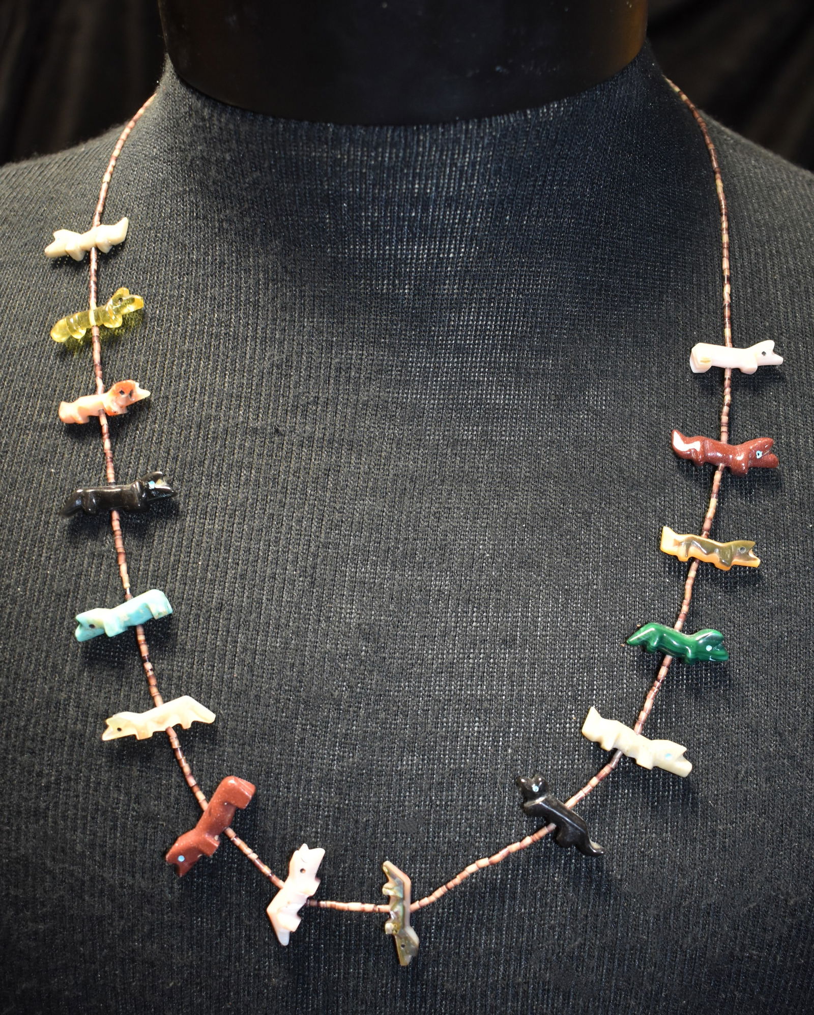 Vintage 25" Zuni Fetish Heishi Necklace: Vintage 25" Zuni Fetish Heishi Necklace. Various hand carved stones and shell. The fetishes appear to be canine. Some with tails some without. The clasp is likely sterling silver. Excellent condition.