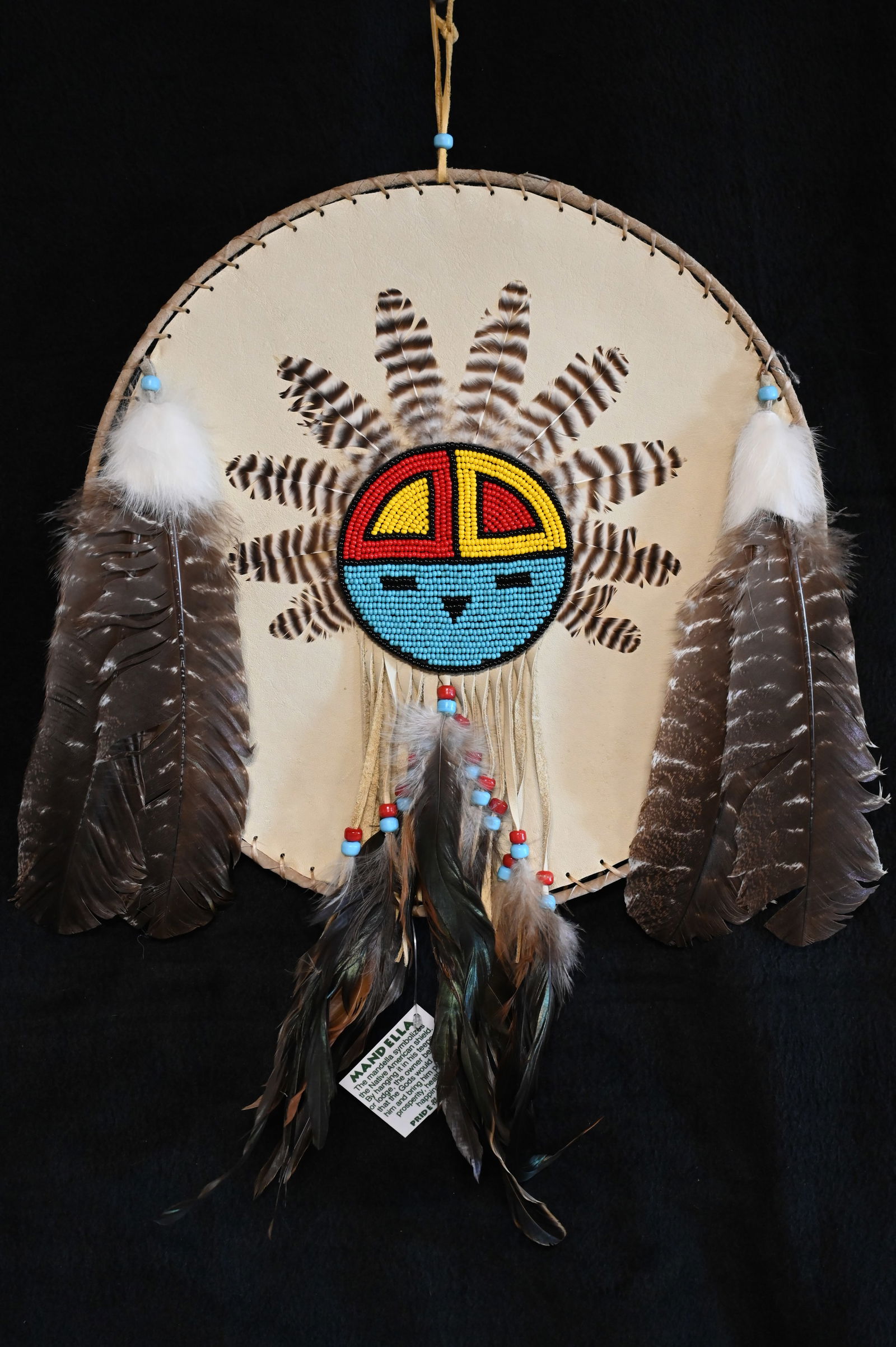 Native American Mandella Shield Hand Crafted by Navajo Betsy Paige Diameter is 14 inches. These: Native American Mandella Shield Hand Crafted by Navajo Betsy Paige Diameter is 14 inches. These would of been hung on the side of their shelter for good Luck/Fortune. Ex: Pride of The Nations Store. T