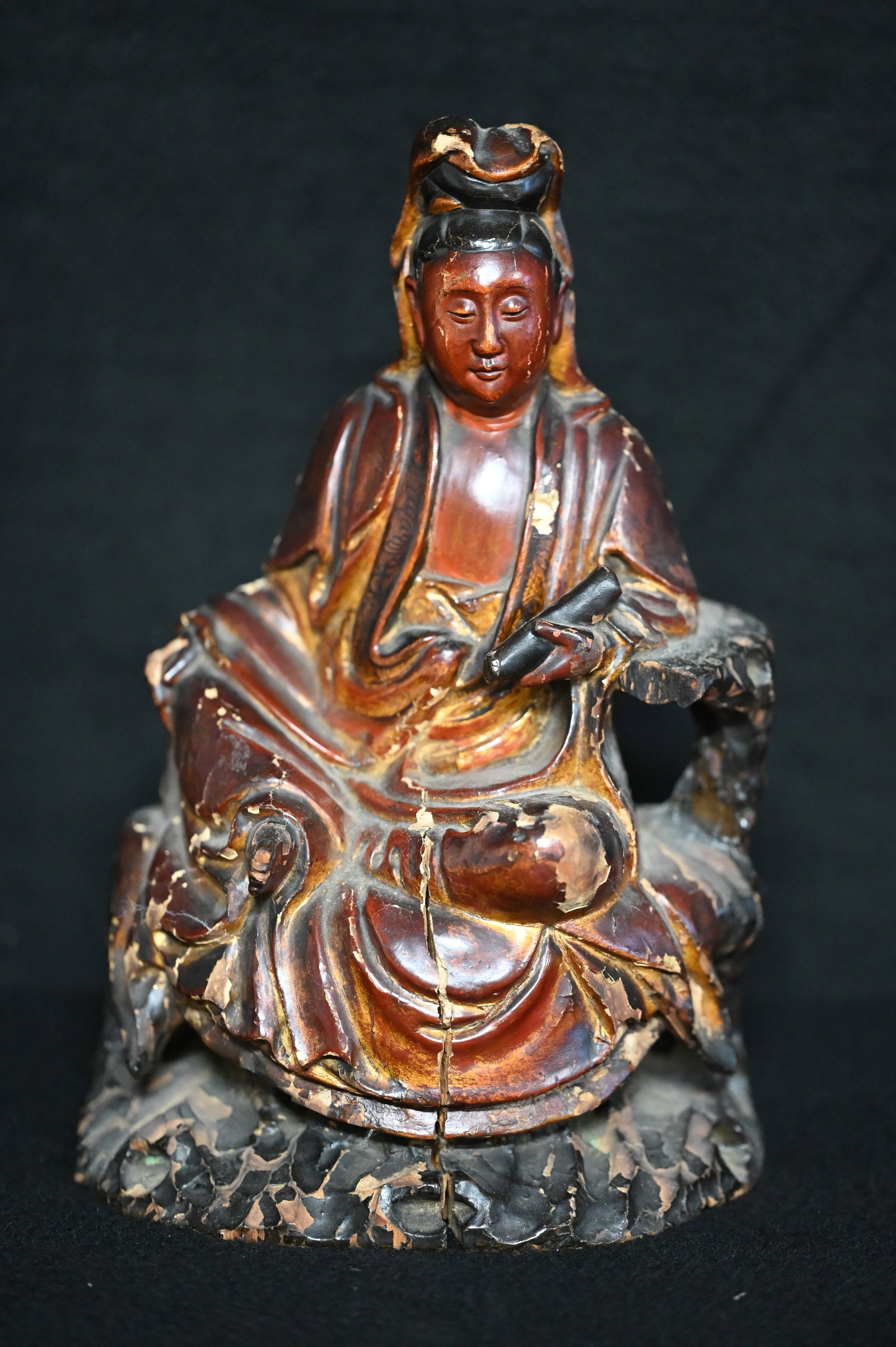 Antique Chinese Lacquered Wood Statue. Hand carved from one piece of wood. Has some chips out and: Antique Chinese Lacquered Wood Statue. Hand carved from one piece of wood. Has some chips out and a crack which are shown in the pictures. Stands 10 1/4 inches tall.