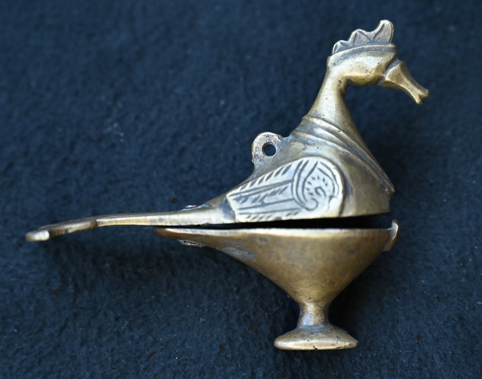 Brass Bird Shaped Surmadani Eye Liner/Makeup container from India. The container spins open from a: Brass Bird Shaped Surmadani Eye Liner/Makeup container from India. The container spins open from a pin in the tail area. The clasp does not keep it closed from use wear. Stands 2 7/8 inches tall and 3
