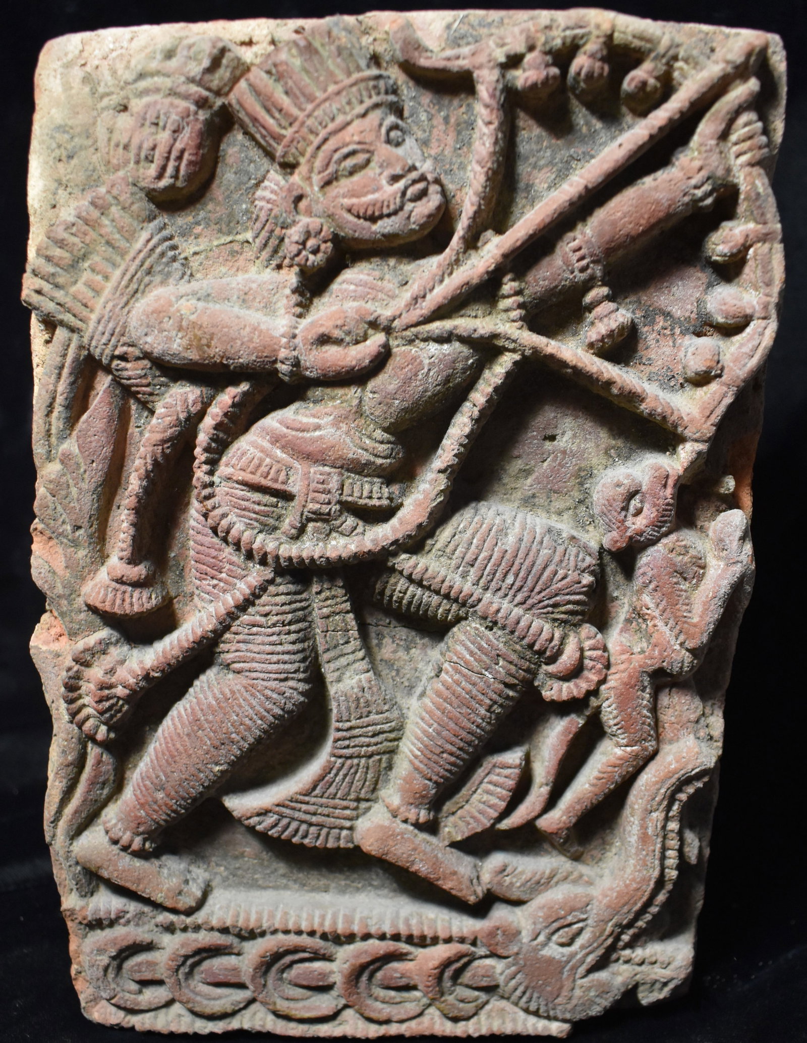12th Century Hindu Temple Stone Carving of Prince Arjuna w/ the Bow Gandiva: 12th Century Hindu Temple Stone Carving of Prince Arjuna w/ the Bow Gandiva. This is a fabulous detailed ancient depiction of Arjuna carved from what appears to be a red sandstone or brick. Arjuna is 