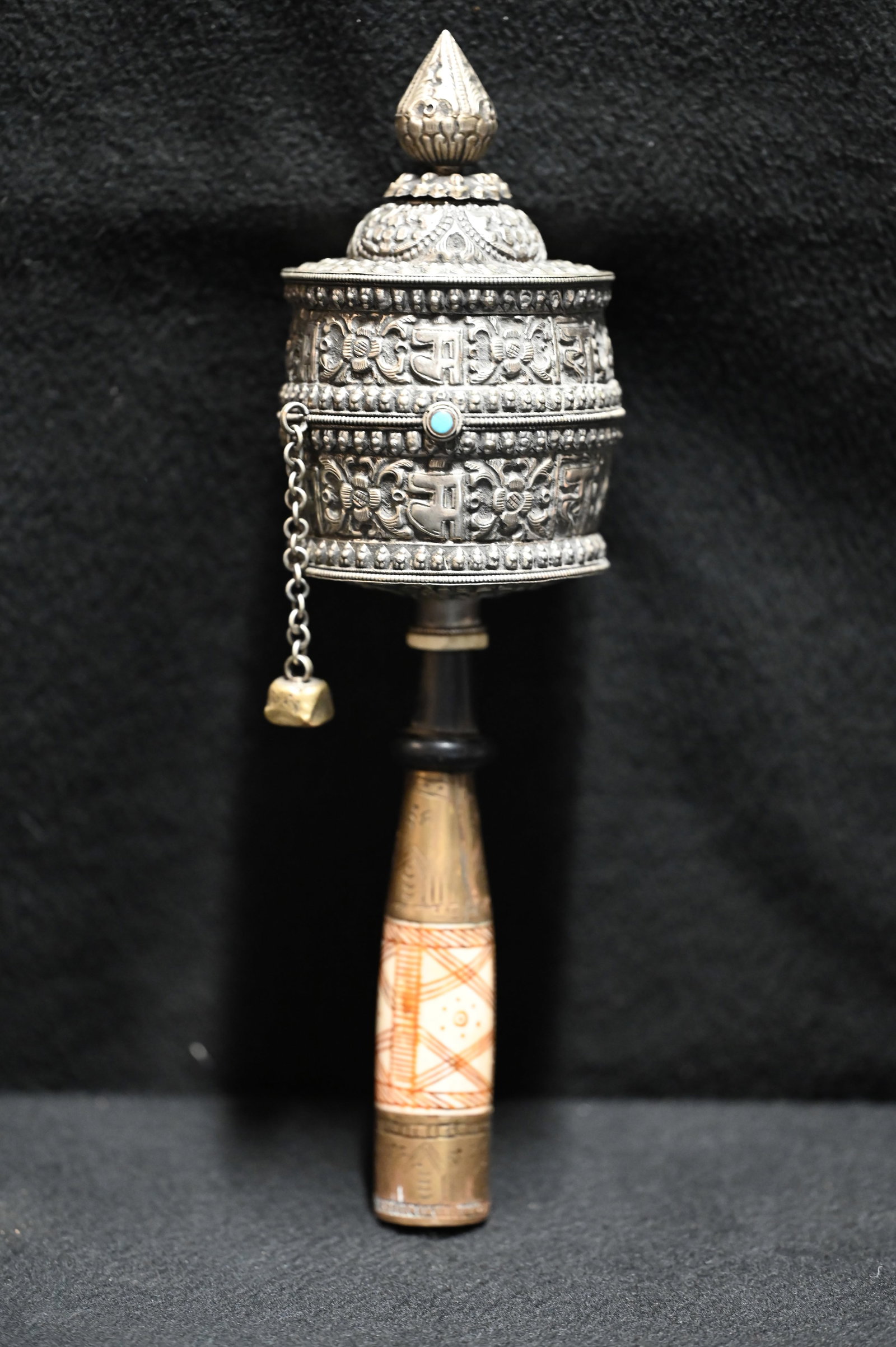 Tibetan Silver Prayer Wheel with Sand script Scrolls. Hand Embossed Silver Exterior with Elaborately: Tibetan Silver Prayer Wheel with Sand script Scrolls. Hand Embossed Silver Exterior with Elaborately Designed Brass and Bone Handle. 11 inches long From Nepal.