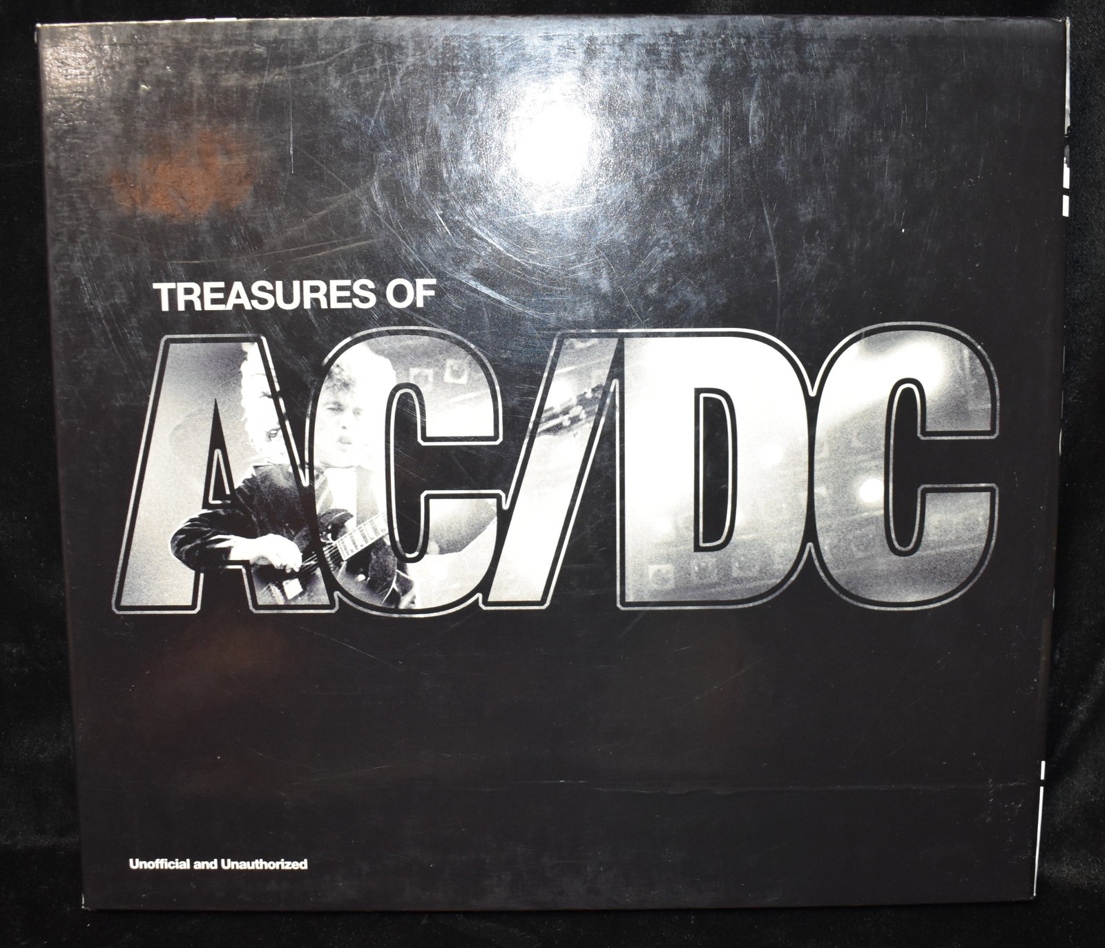 Treasures of AC/DC w/ Posters and other Ephemera 2012: Treasures of AC/DC by Ewing, Jerry. Published by Sterling, 2012. Mint or near mint with its original sleeve, posters and misc AC/DC ephemera that come with the book as pictured. Hardback.